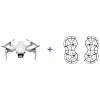 DJI Mini 4K Fly More Combo в сером корпусе с защитой пропеллеров, вид спереди, на фоне размытого городского пейзажа Новосибирска.