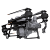 DJI Agras T70, агродрон с распылителем, готовый к работе в поле.